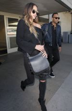 CHRISSY TEIGEN at Los Angeles International Airport 12/03/2016
