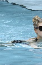 CHARLOTTE MCKINNEY in Bikini at a Pool in Miami 02/18/2017