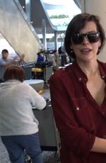 MILLA JOVOVICH Smoking a Cigarette at LAX Airport in Los Angeles 02/04/2017