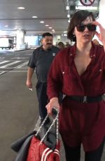 MILLA JOVOVICH Smoking a Cigarette at LAX Airport in Los Angeles 02/04/2017