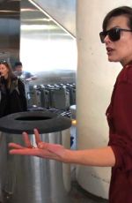 MILLA JOVOVICH Smoking a Cigarette at LAX Airport in Los Angeles 02/04/2017