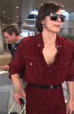 MILLA JOVOVICH Smoking a Cigarette at LAX Airport in Los Angeles 02/04/2017