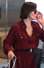MILLA JOVOVICH Smoking a Cigarette at LAX Airport in Los Angeles 02/04/2017