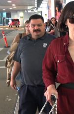 MILLA JOVOVICH Smoking a Cigarette at LAX Airport in Los Angeles 02/04/2017