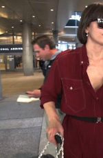 MILLA JOVOVICH Smoking a Cigarette at LAX Airport in Los Angeles 02/04/2017