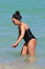 TIA MOWRY in Swimsuit at a Beach in Miami 02/27/2017
