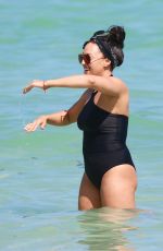 TIA MOWRY in Swimsuit at a Beach in Miami 02/27/2017