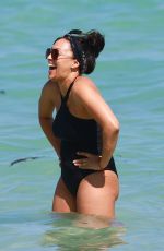 TIA MOWRY in Swimsuit at a Beach in Miami 02/27/2017