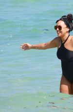 TIA MOWRY in Swimsuit at a Beach in Miami 02/27/2017