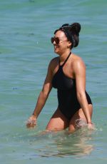 TIA MOWRY in Swimsuit at a Beach in Miami 02/27/2017