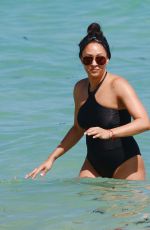 TIA MOWRY in Swimsuit at a Beach in Miami 02/27/2017