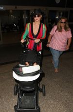 CHRISSY TEIGEN at LAX Airport in Los Angeles 03/23/2017