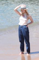 ELLE FANNING on the Set of a Photoshooting on the Beach in Cannes 05/20/2017