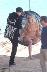 ELLE FANNING on the Set of a Photoshooting on the Beach in Cannes 05/20/2017