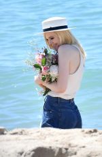 ELLE FANNING on the Set of a Photoshooting on the Beach in Cannes 05/20/2017