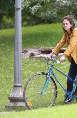 KATIE HOLMES Riding a Bike on the Set of The Gift in Montreal 06/22/2017