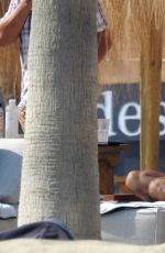 EVA LONGORIA in Swimsuit on Sunbed at a Beach in Marbella 07/13/2017