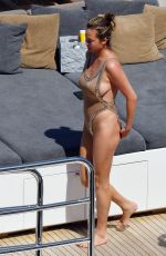 CHRISSY TEIGEN in Swimsuit at a Boat in Corsica 08/28/2017