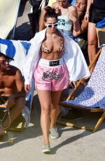 DUA LIPA Sunbathing at a Beach in Capri 08/29/2017