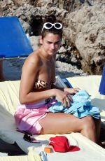 DUA LIPA Sunbathing at a Beach in Capri 08/29/2017