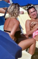 DUA LIPA Sunbathing at a Beach in Capri 08/29/2017