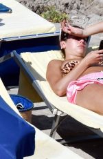 DUA LIPA Sunbathing at a Beach in Capri 08/29/2017