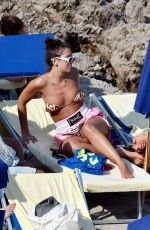 DUA LIPA Sunbathing at a Beach in Capri 08/29/2017