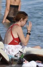 LINDSAY LOHAN in Swimsuit at Nammos Beach in Mykonos 08/21/2017
