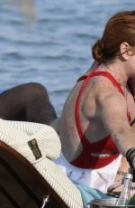 LINDSAY LOHAN in Swimsuit at Nammos Beach in Mykonos 08/21/2017