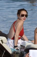 LINDSAY LOHAN in Swimsuit at Nammos Beach in Mykonos 08/21/2017