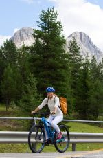 MICHELLE HUNZIKER Out Riding a Bike in San Cassiano in Badia 08/13/2017