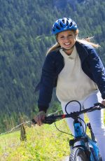 MICHELLE HUNZIKER Out Riding a Bike in San Cassiano in Badia 08/13/2017