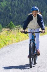 MICHELLE HUNZIKER Out Riding a Bike in San Cassiano in Badia 08/13/2017