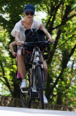 MICHELLE HUNZIKER Ridig a Bicycle Out in Bergamo 08/05/2017