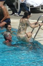 ASIA ARGENTO in Bikini and Anthony Bourdain at a Pool in Rome 09/20/2017