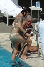 ASIA ARGENTO in Bikini and Anthony Bourdain at a Pool in Rome 09/20/2017