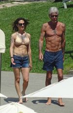 ASIA ARGENTO in Bikini and Anthony Bourdain at a Pool in Rome 09/20/2017