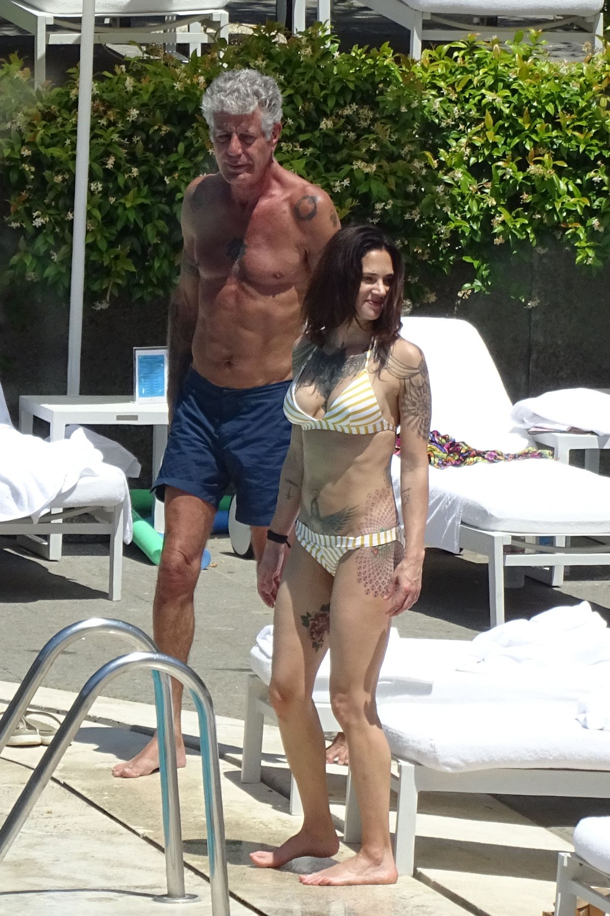 ASIA ARGENTO in Bikini and Anthony Bourdain at a Pool in Rome 09/20/2017.