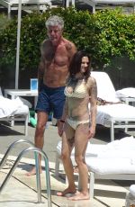 ASIA ARGENTO in Bikini and Anthony Bourdain at a Pool in Rome 09/20/2017