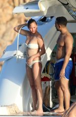 CHRISSY TEIGEN in Bikini at a Boat in Sardinia 08/30/2017