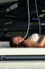 CHRISSY TEIGEN in Bikini at a Boat in Sardinia 08/30/2017