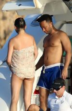 CHRISSY TEIGEN in Bikini at a Boat in Sardinia 08/30/2017