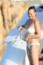 CHRISSY TEIGEN in Bikini at a Boat in Sardinia 08/30/2017