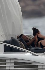 CHRISSY TEIGEN in Bikini at a Yacht in Sardinia 08/31/2017