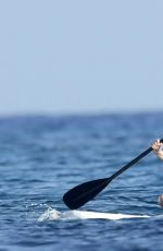 CHRISSY TEIGEN Paddleboarding in Sardinia 08/30/2017