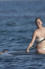 CHRISSY TEIGEN Paddleboarding in Sardinia 08/30/2017