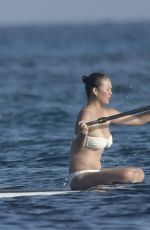 CHRISSY TEIGEN Paddleboarding in Sardinia 08/30/2017