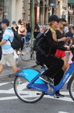 PARIS HILTON and Chris Zylka Riding Bicycles Out in New York 09/17/2017