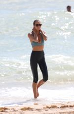 ELLE MACPHERSON in Bikini Top and Leggings at a Beach in Miami 10/13/2017