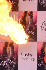 KATIE PRICE Fire Breathing at Her New Book Playing with Fire Photocall in London 01/17/2017